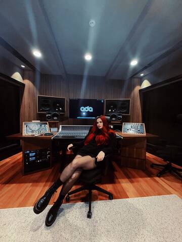 CERES inside the studio, sitting confidently in front of professional audio equipment during a recording session.